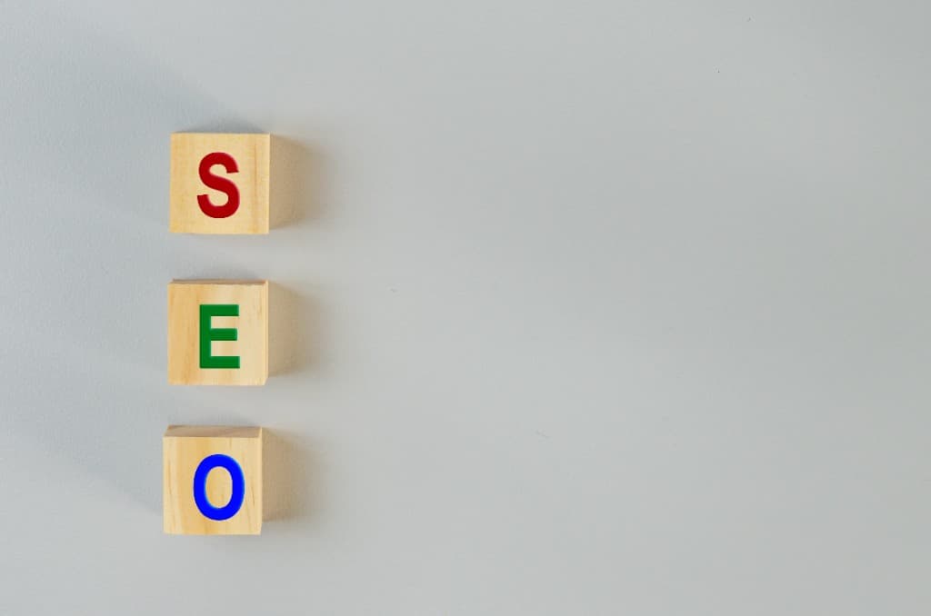 Wooden blocks spelling SEO on a gray background